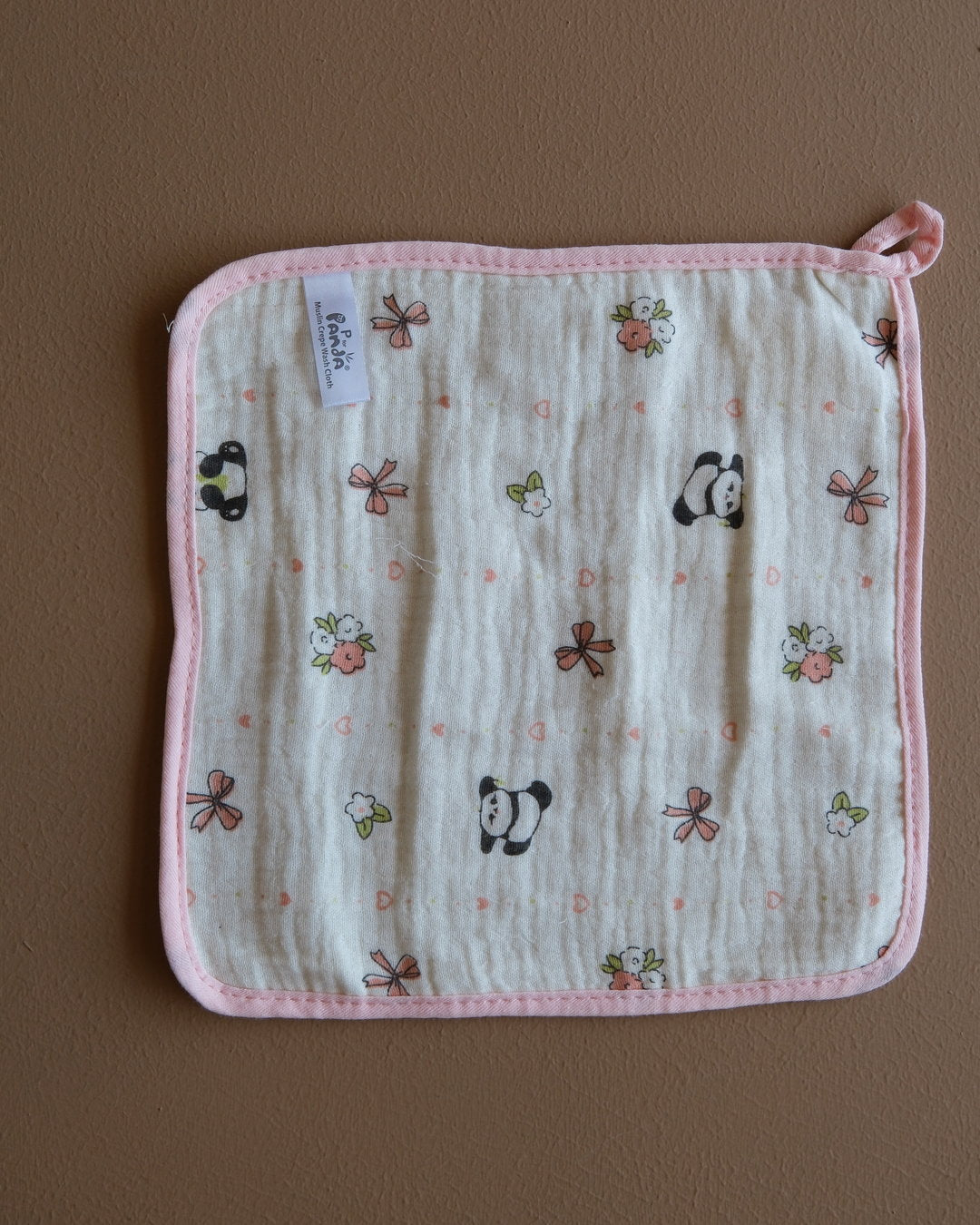 Assorted printed baby washcloths with colorful animal, floral, rainbow, and playful designs