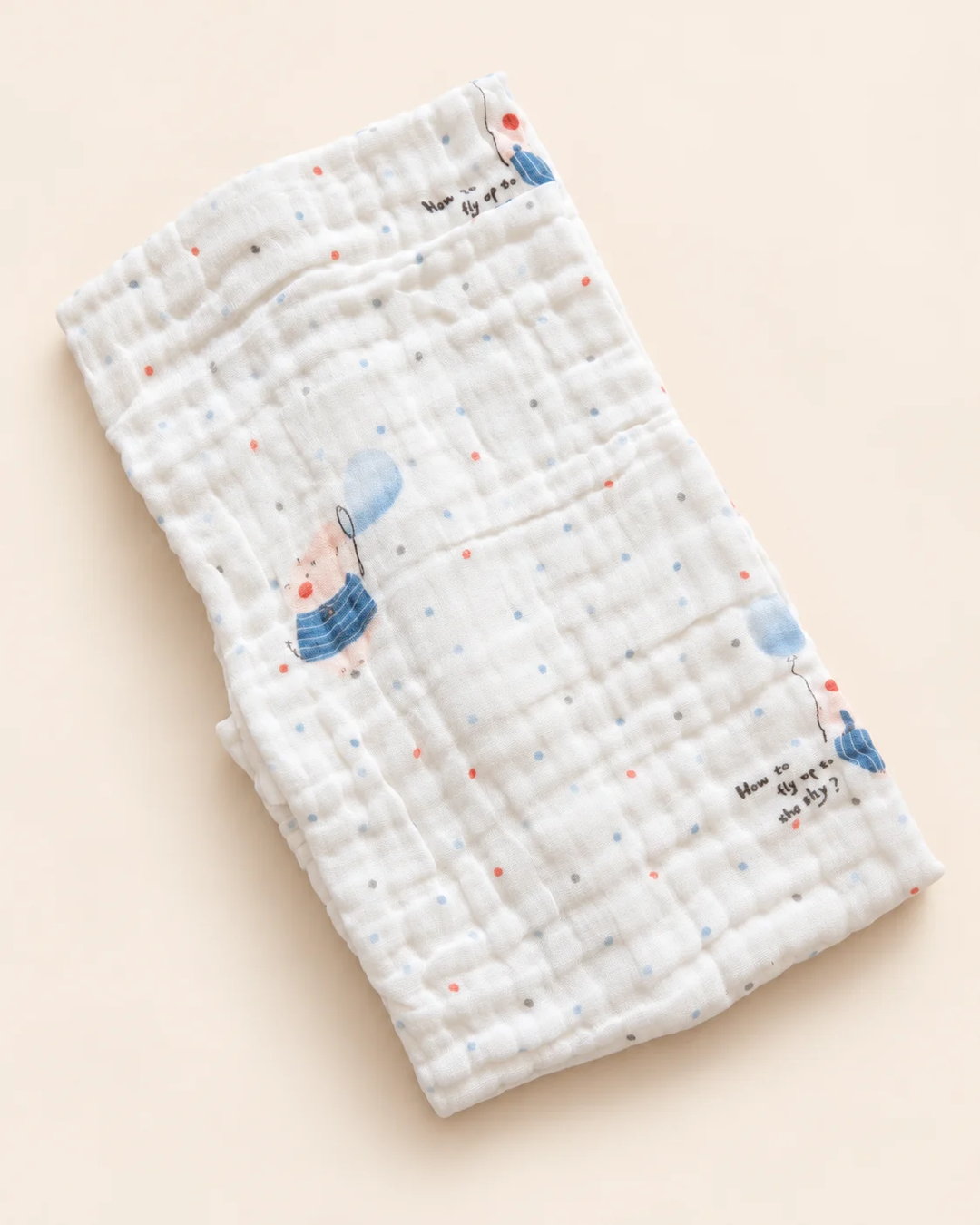 Printed muslin baby towel with playful elephant, unicorn, vehicle, and multicolor designs