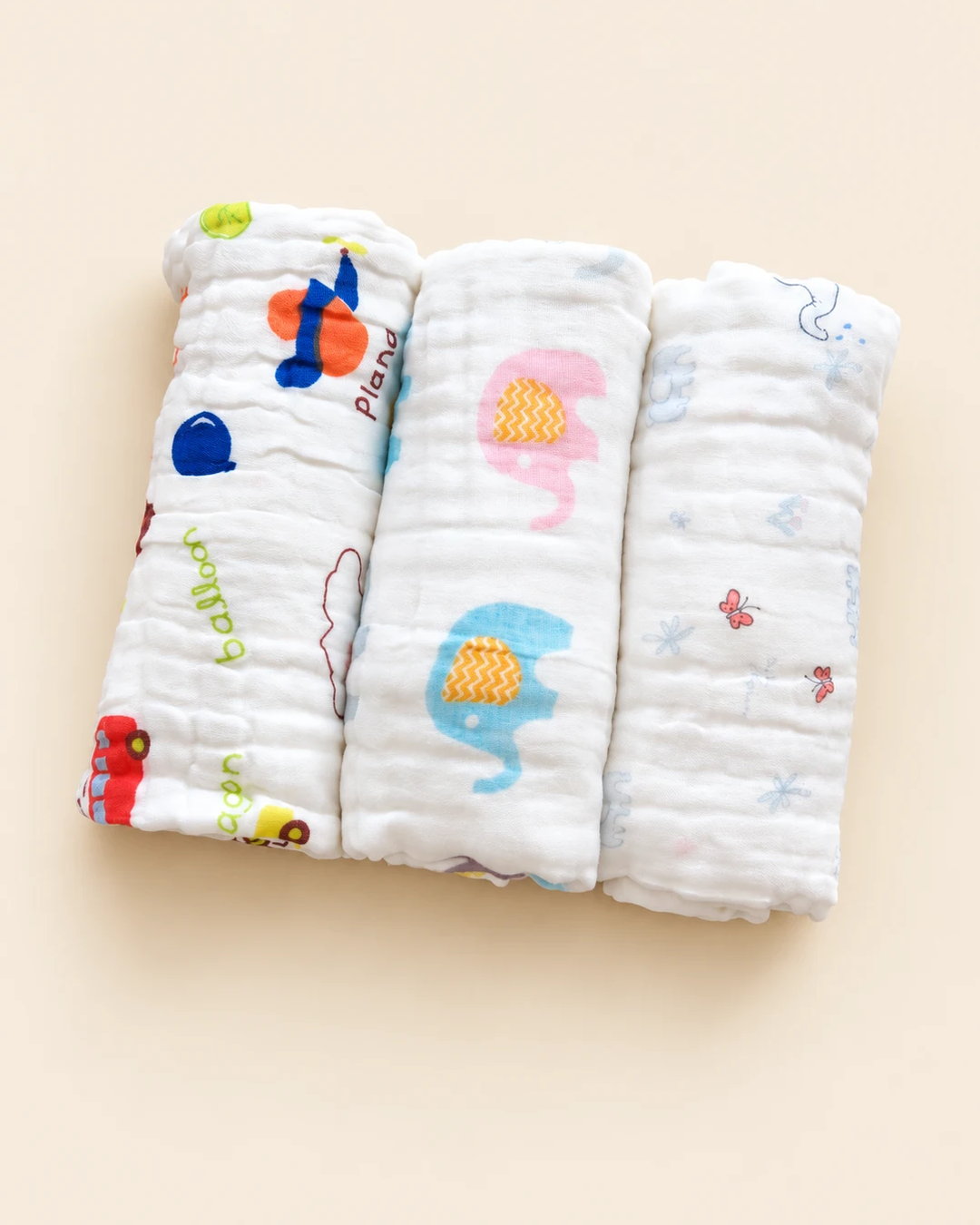Printed muslin baby towel with playful elephant, unicorn, vehicle, and multicolor designs