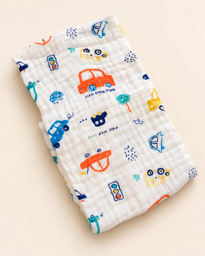 Printed muslin baby towel with playful elephant, unicorn, vehicle, and multicolor designs
