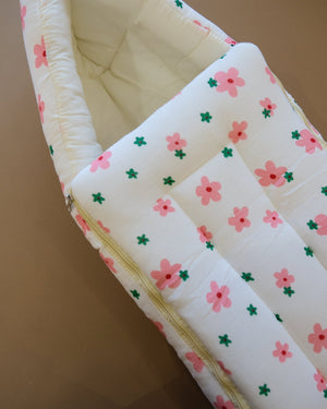 Ivory padded newborn sleeping bag with pink and green floral print
