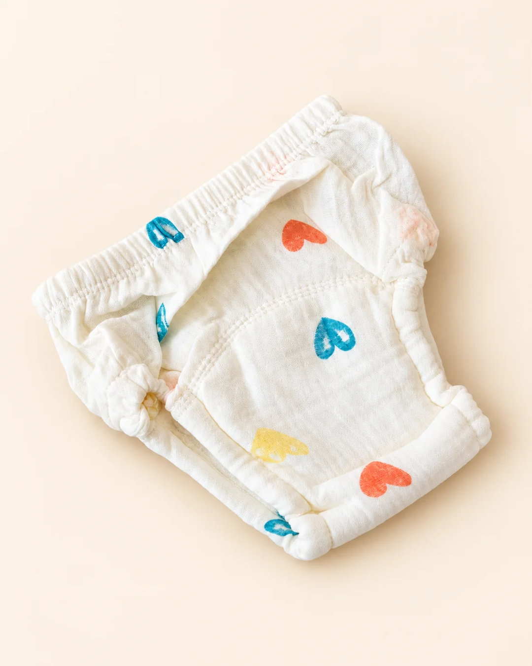 Reusable off-white cloth diaper with playful printed designs