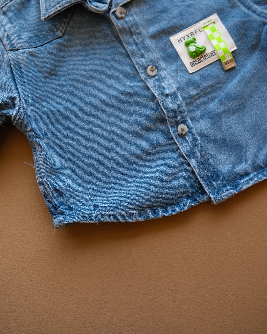 Blue long-sleeve collared baby shirt with button closure and chest pockets