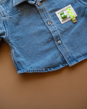 Blue long-sleeve collared baby shirt with button closure and chest pockets