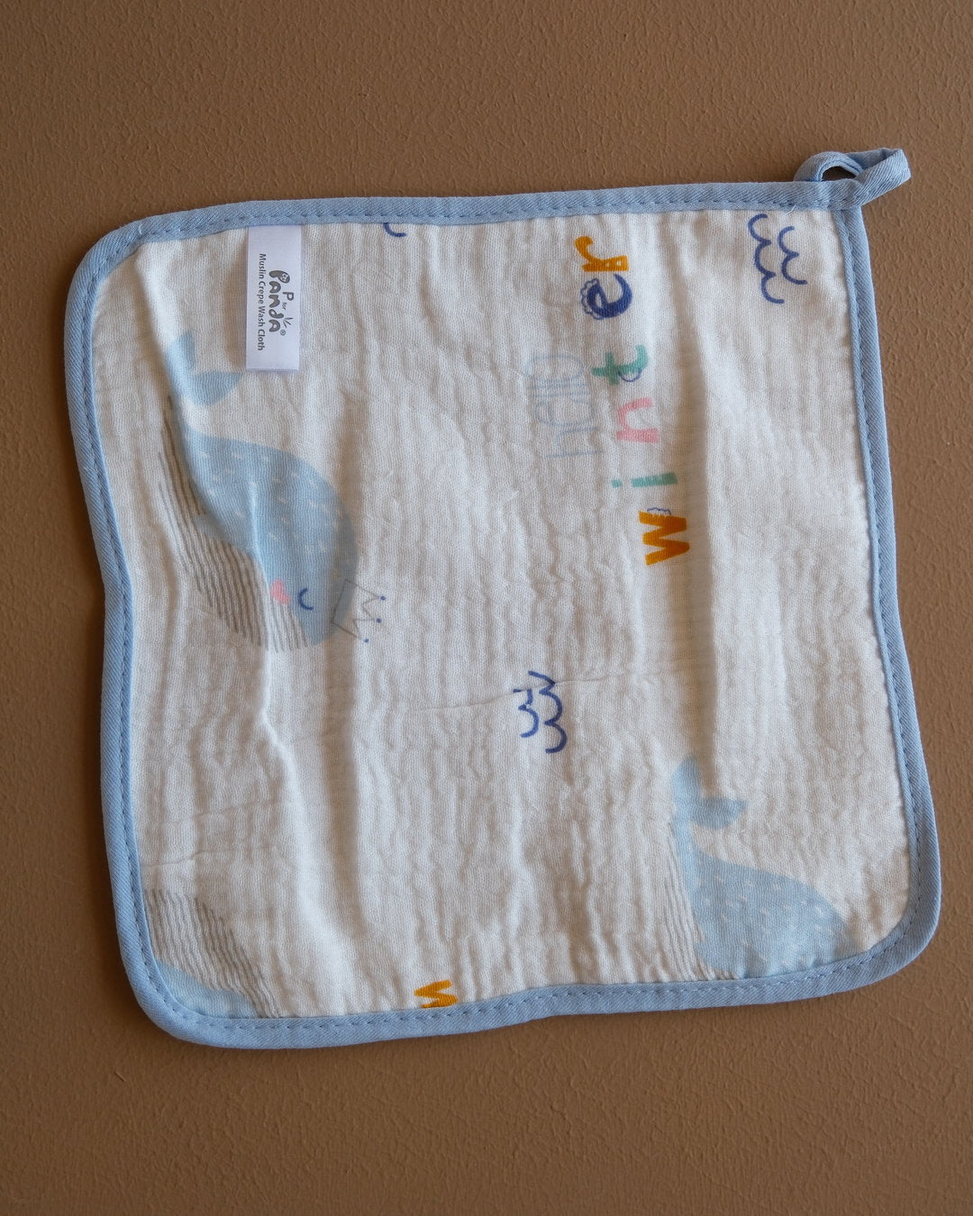 Assorted printed baby washcloths with colorful animal, floral, rainbow, and playful designs