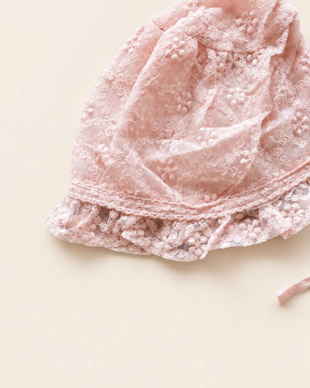 Delicate floral lace baby bonnet with tie straps