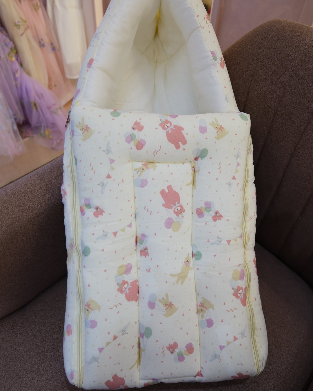Ivory padded newborn sleeping bag with pink and green floral print