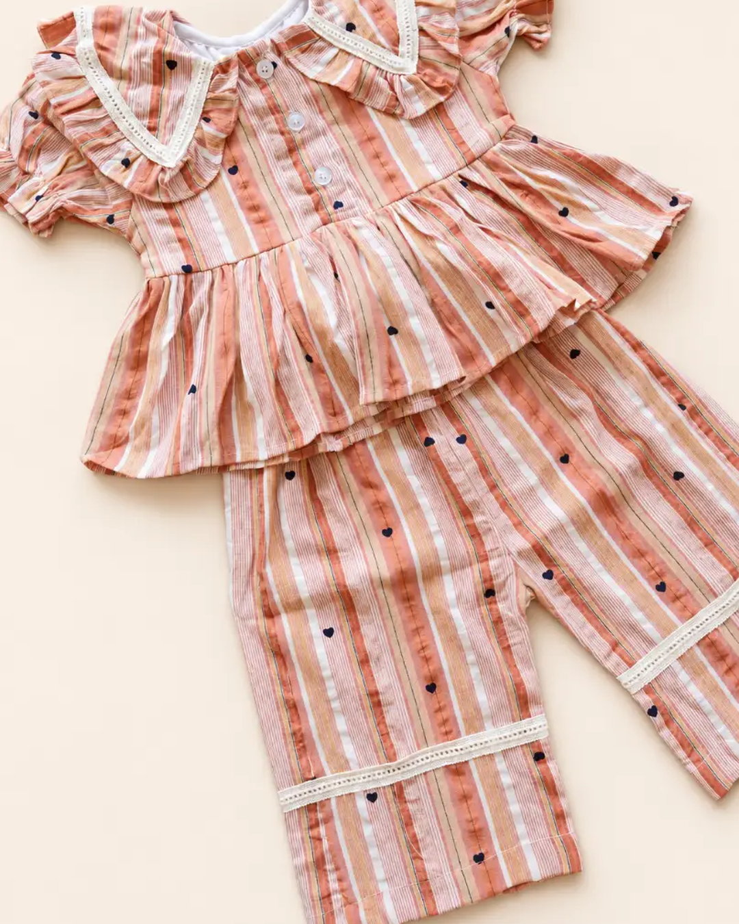 Striped girls frock set with heart motifs, ruffled sleeves, lace trim, and matching pants