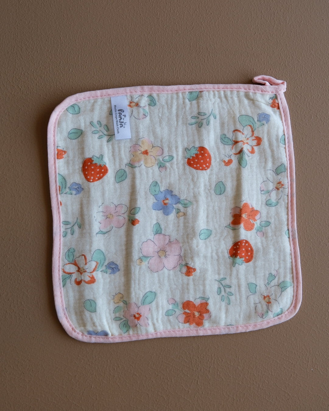 Assorted printed baby washcloths with colorful animal, floral, rainbow, and playful designs