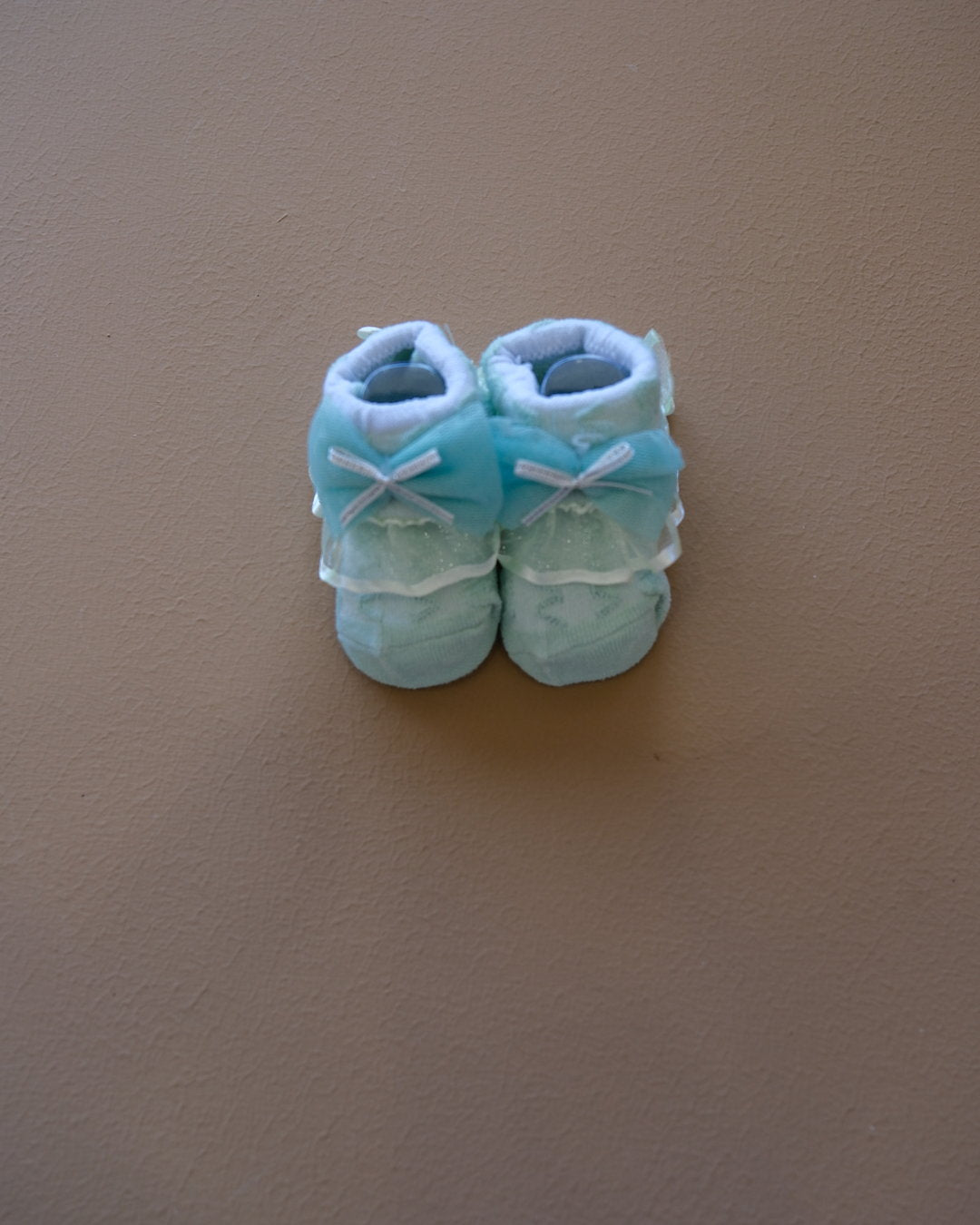 Newborn baby socks with decorative bows in pastel colors