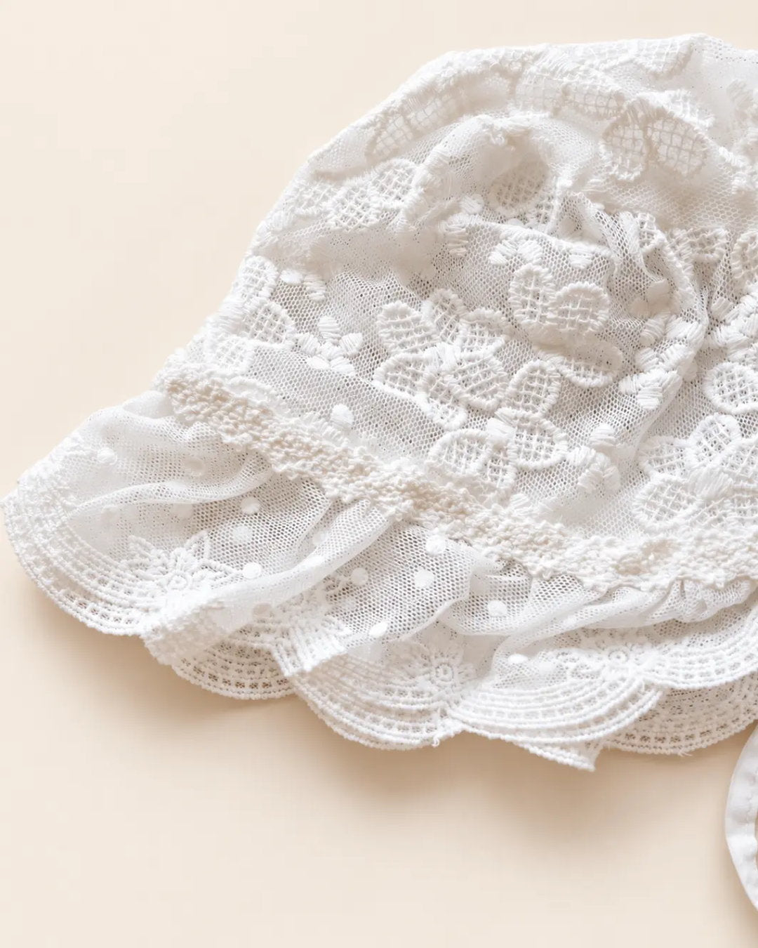 Delicate floral lace baby bonnet with tie straps