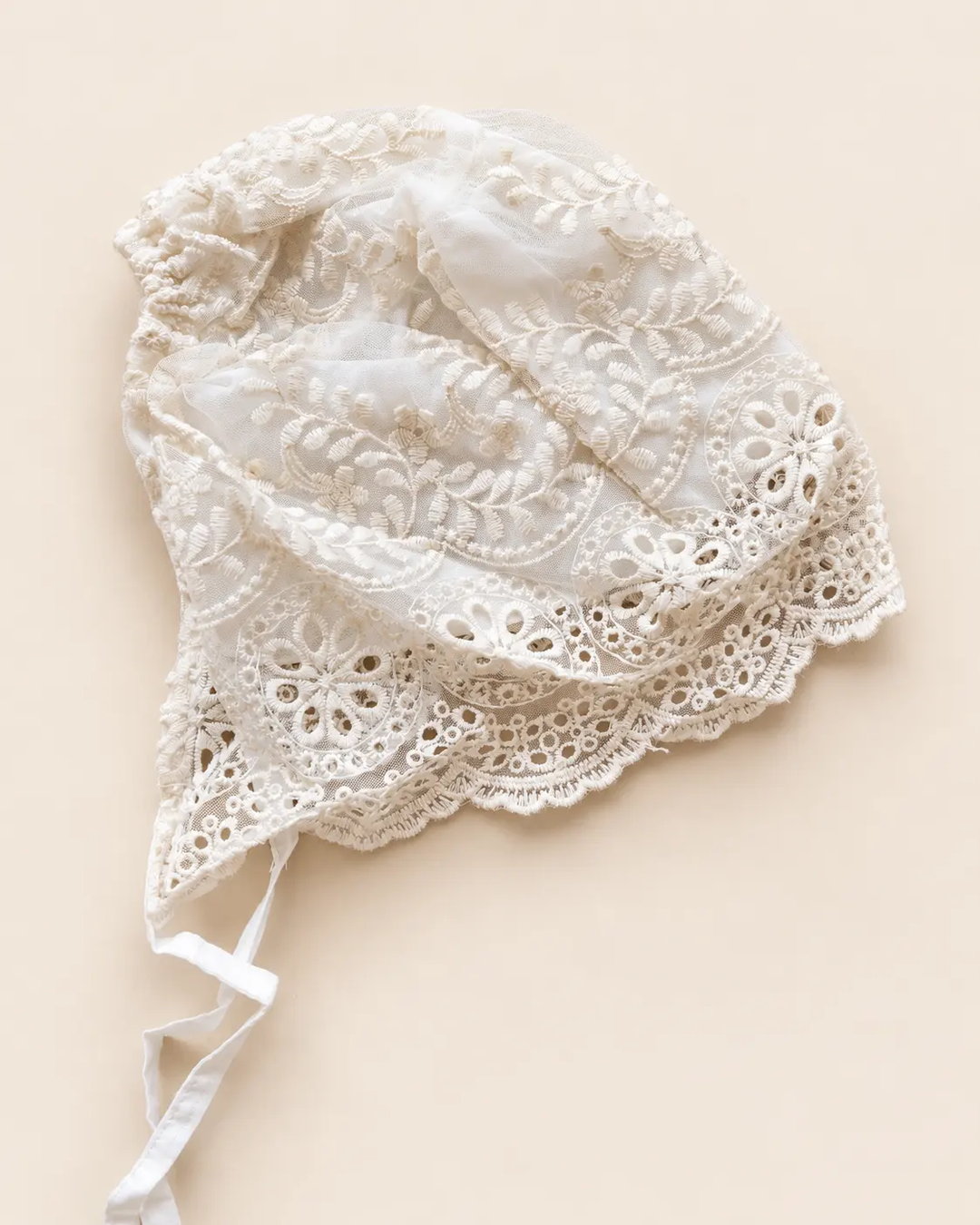 Delicate floral lace baby bonnet with tie straps