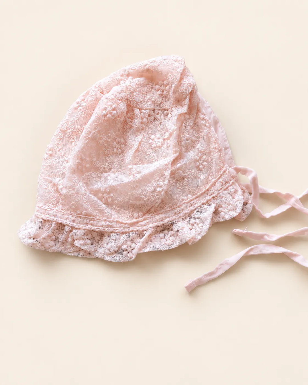 Delicate floral lace baby bonnet with tie straps