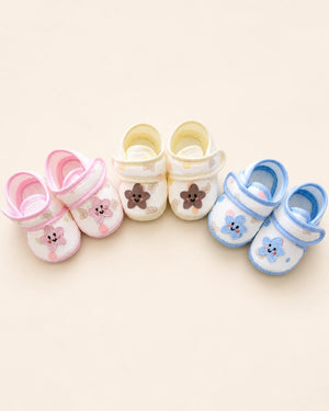 Baby booties with star applique, bear print, and pastel trim