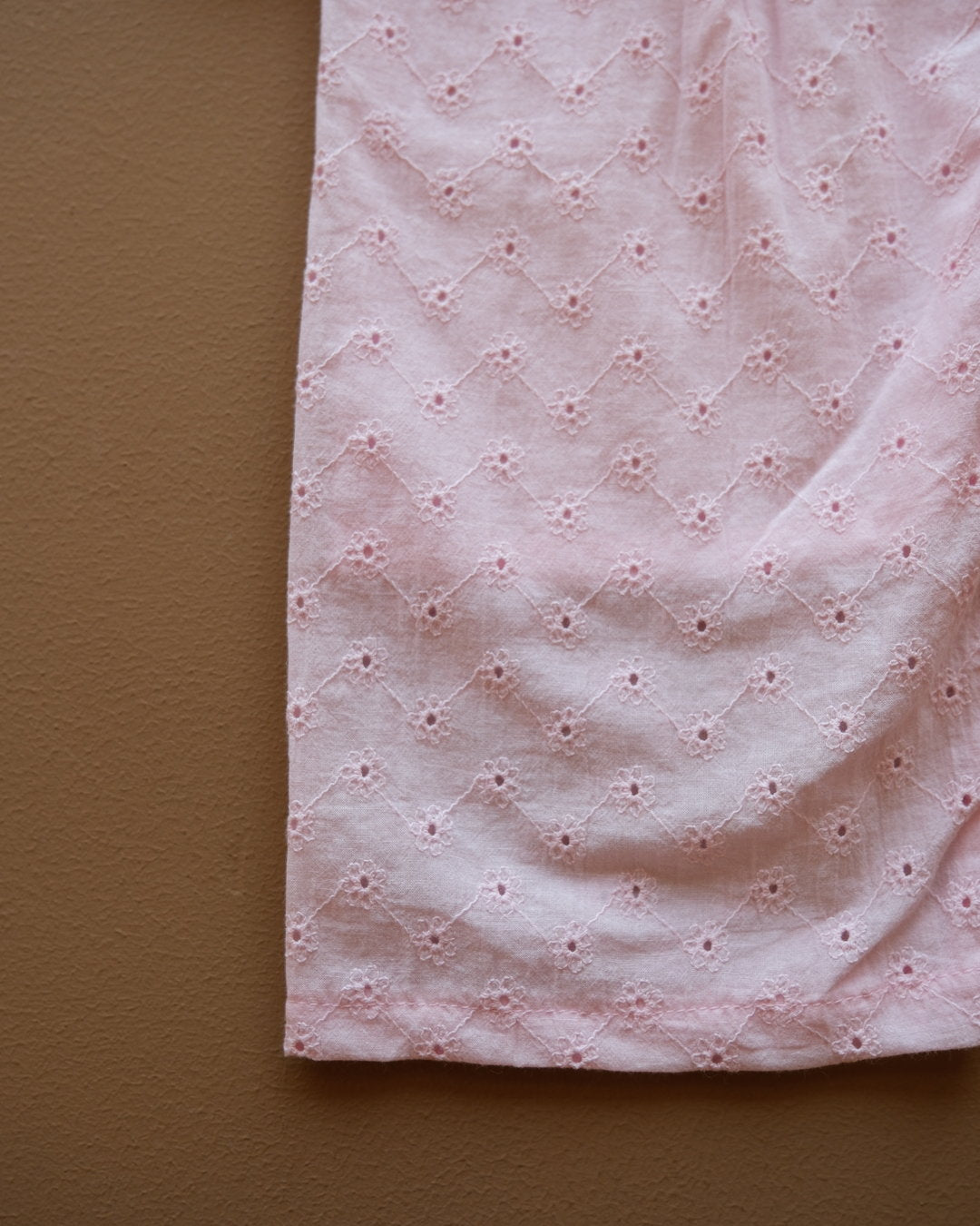 Soft pink sleeveless floral eyelet jumpsuit with wide-leg pants
