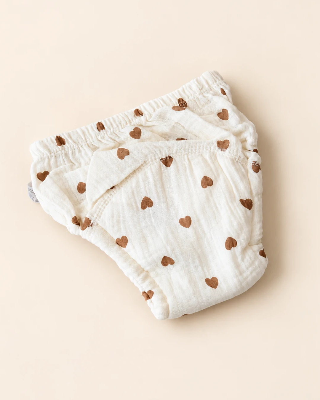 Reusable off-white cloth diaper with playful printed designs