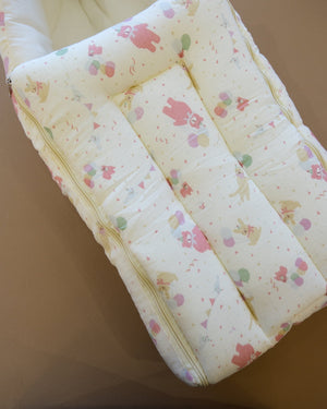 Ivory padded newborn sleeping bag with pink and green floral print