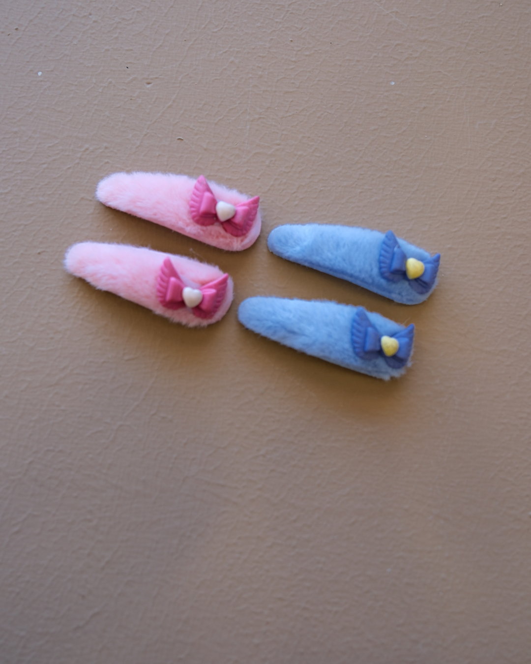 Assorted colorful decorative hair clips with bows, flowers, and playful motifs