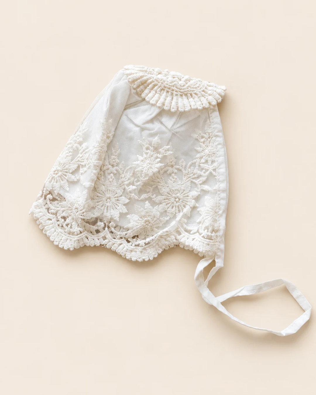 Delicate floral lace baby bonnet with tie straps