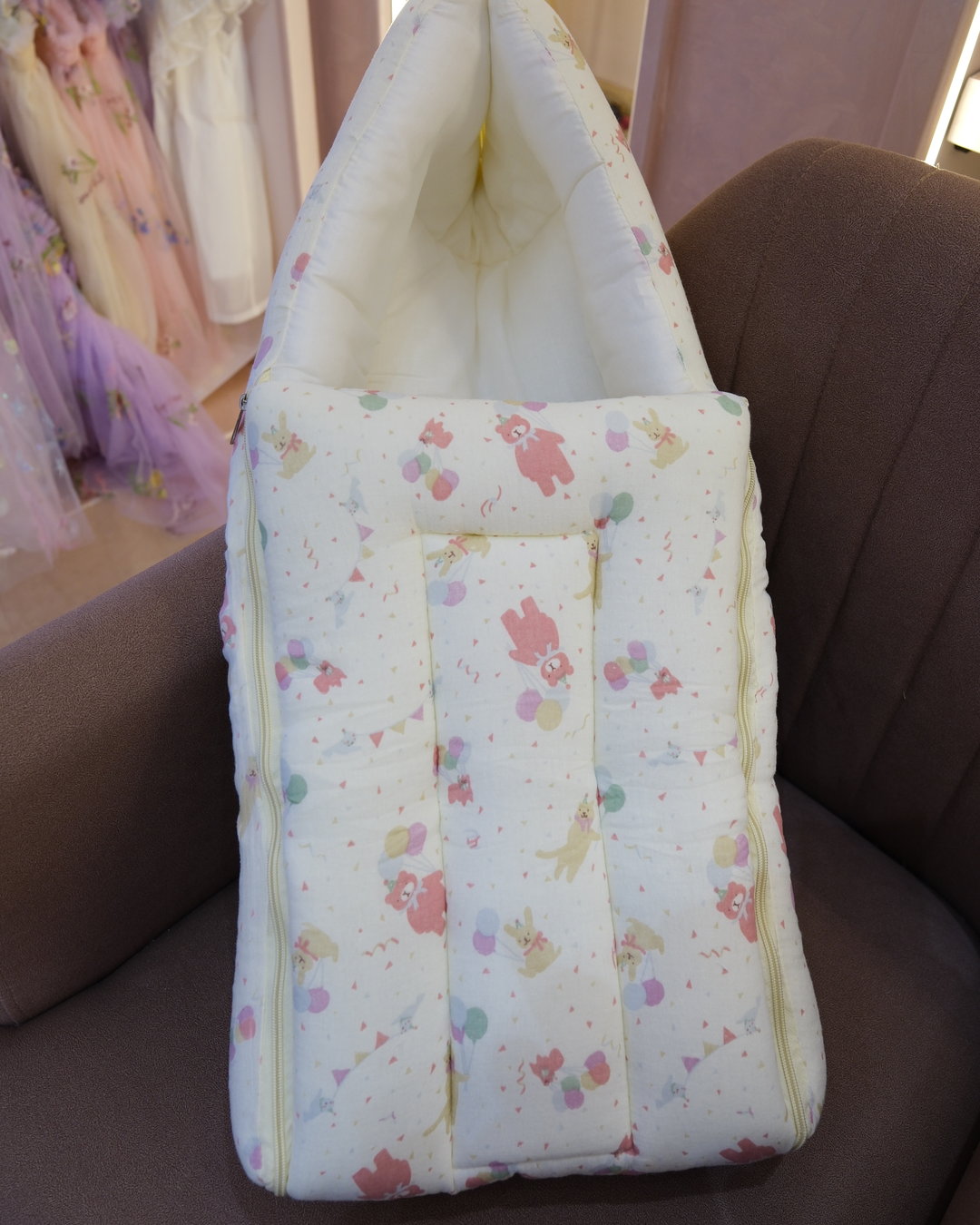Ivory padded newborn sleeping bag with pink and green floral print