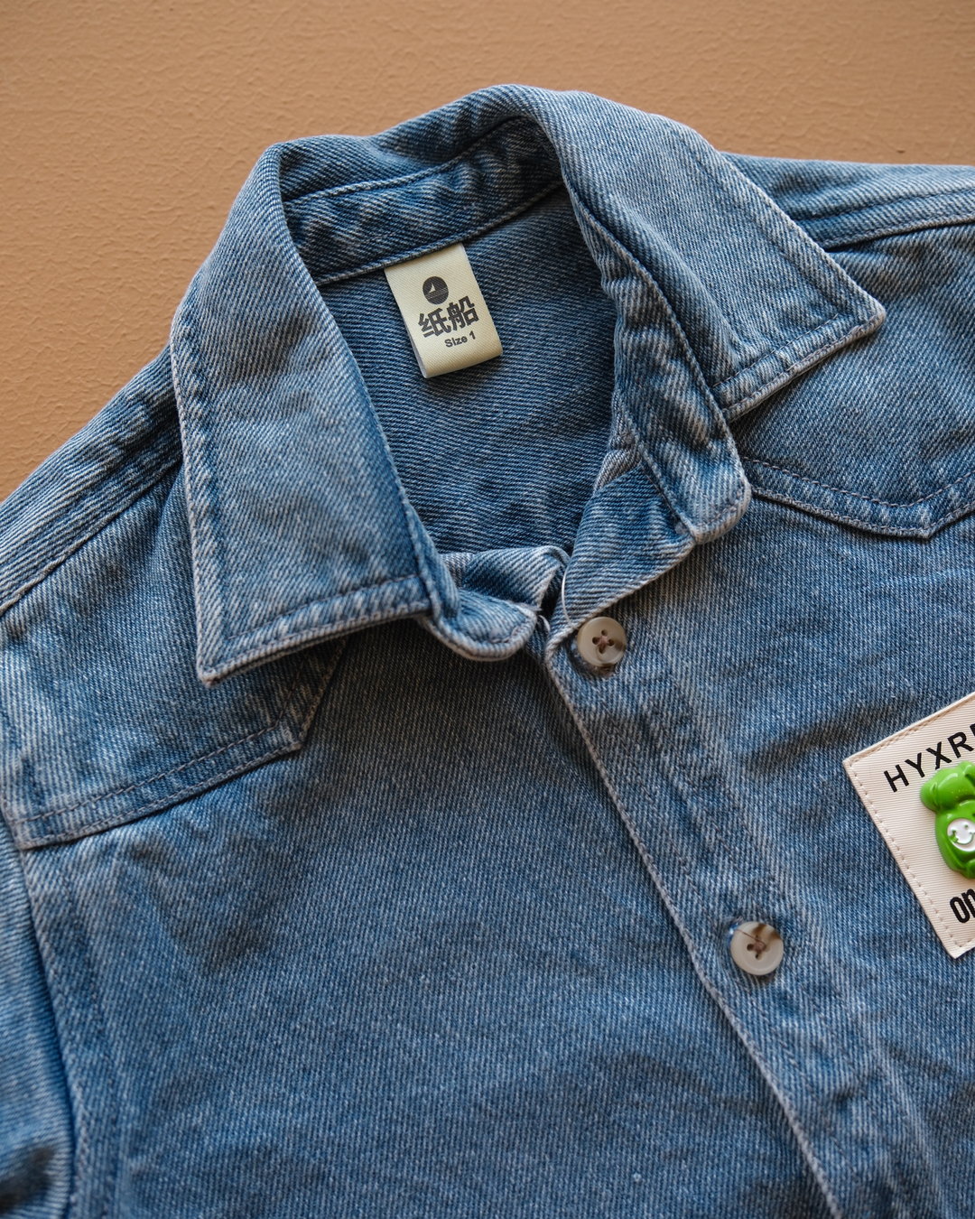 Blue long-sleeve collared baby shirt with button closure and chest pockets