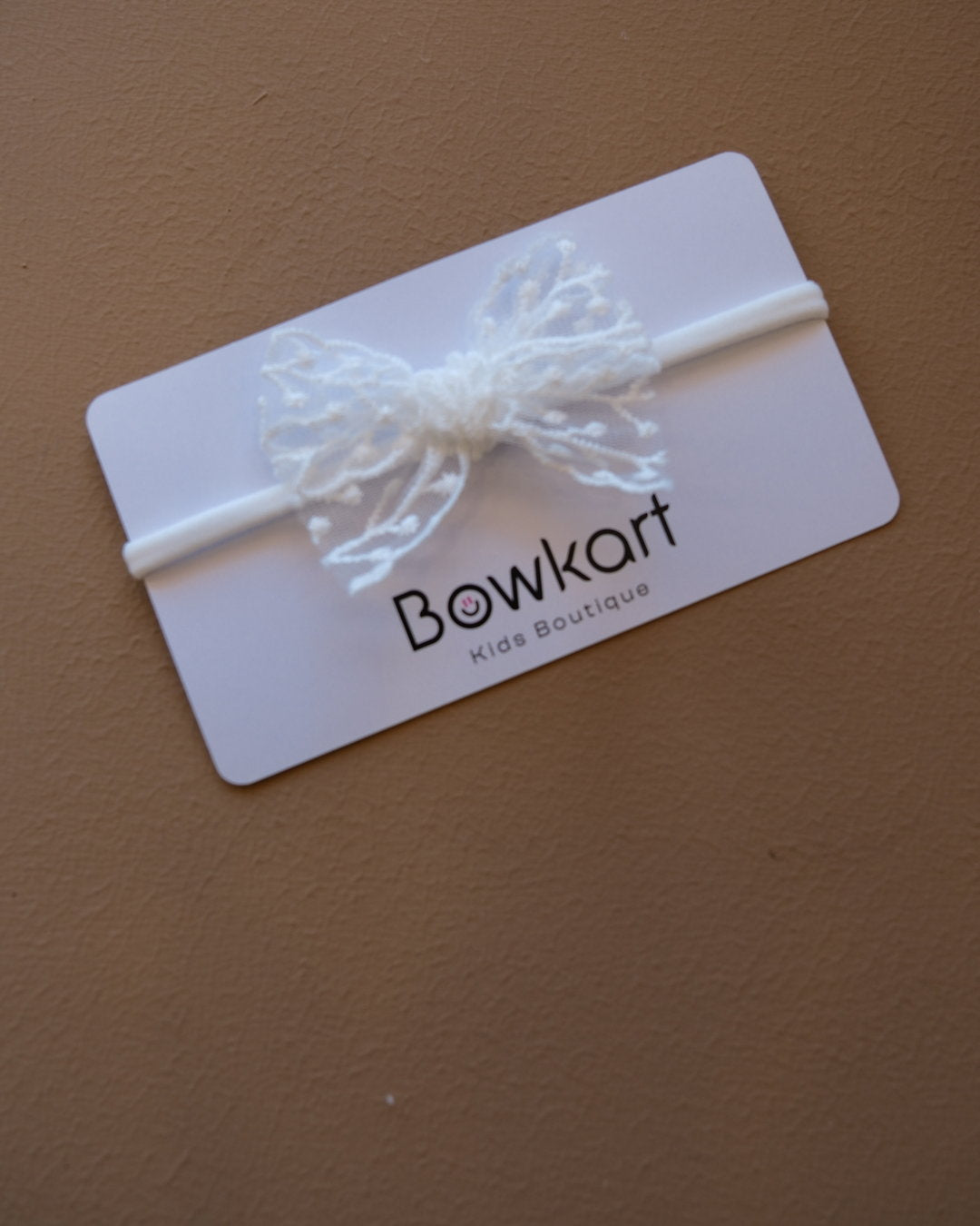 Baby headband with a delicate floral lace bow