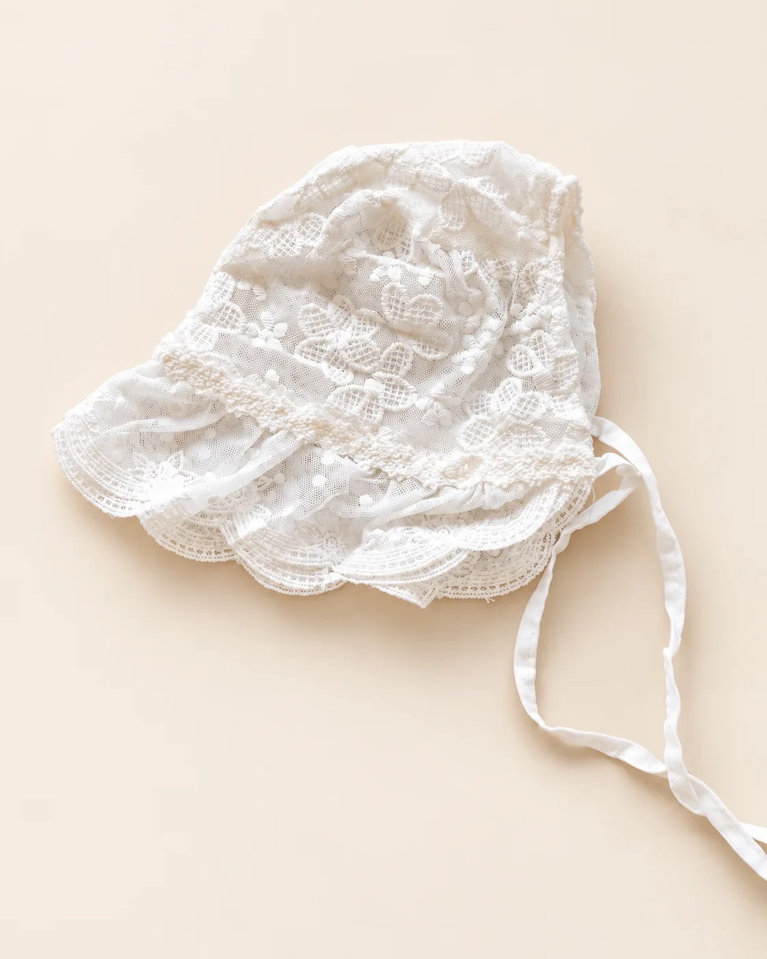 Delicate floral lace baby bonnet with tie straps