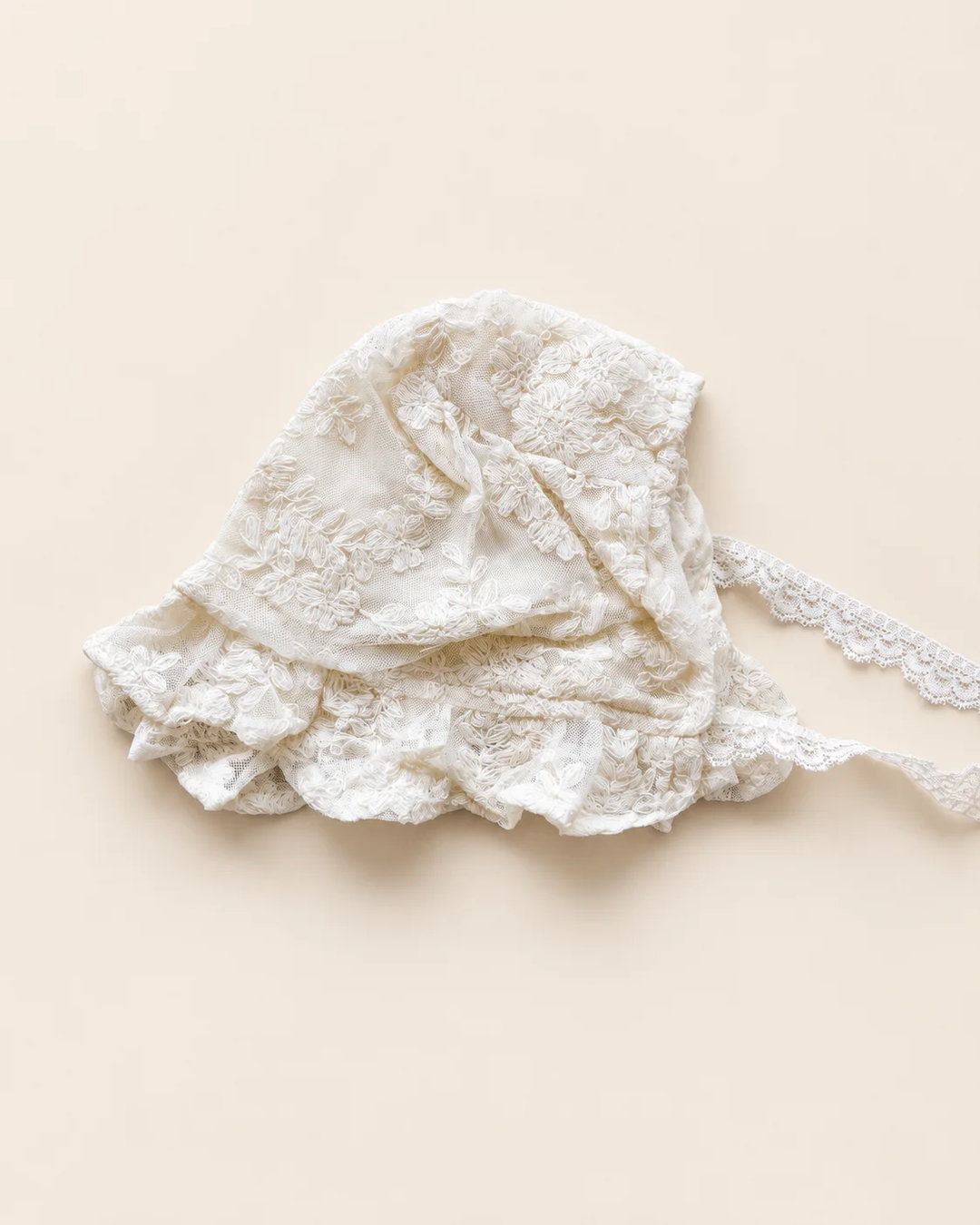 Delicate floral lace baby bonnet with tie straps