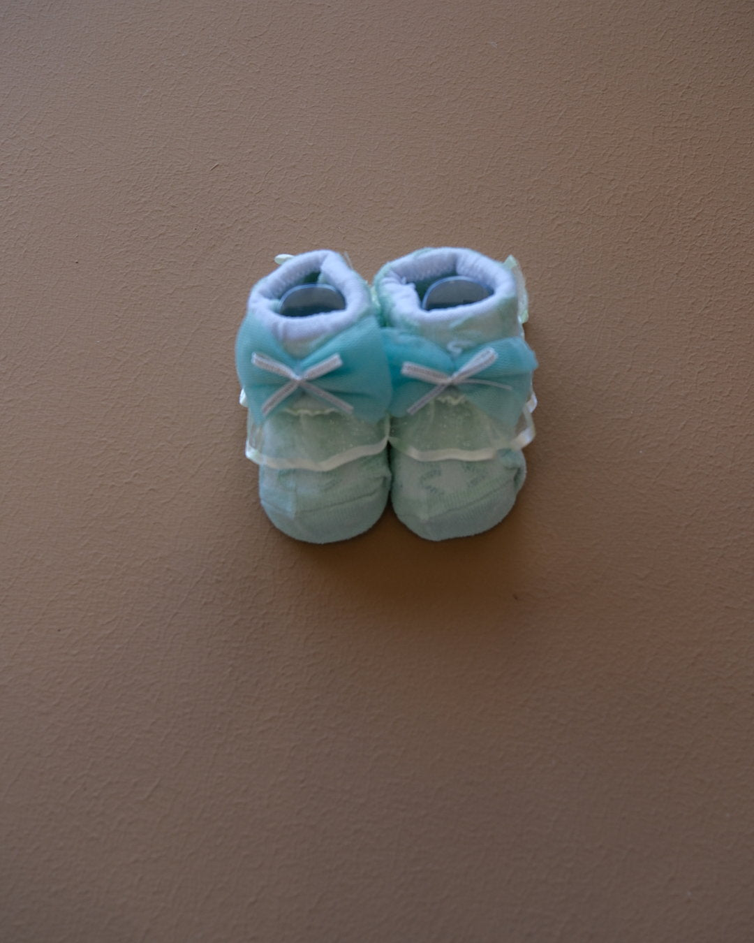 Newborn baby socks with decorative bows in pastel colors