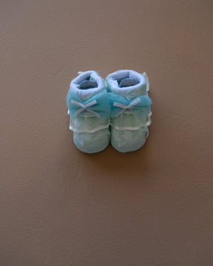Newborn baby socks with decorative bows in pastel colors