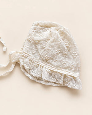 Delicate floral lace baby bonnet with tie straps