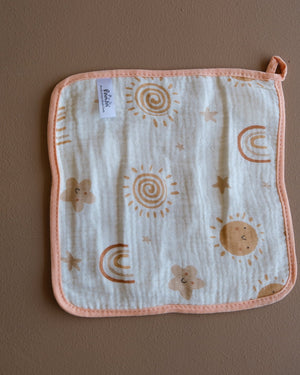 Assorted printed baby washcloths with colorful animal, floral, rainbow, and playful designs