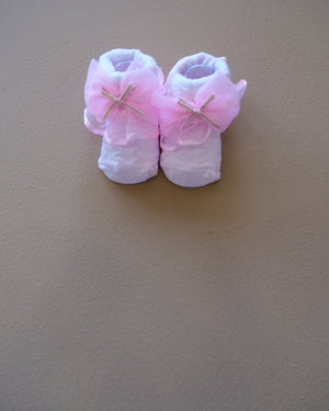 Newborn baby socks with decorative bows in pastel colors