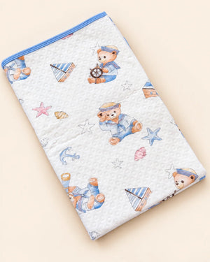 Printed white baby dry sheet with quilted texture and playful nursery illustrations