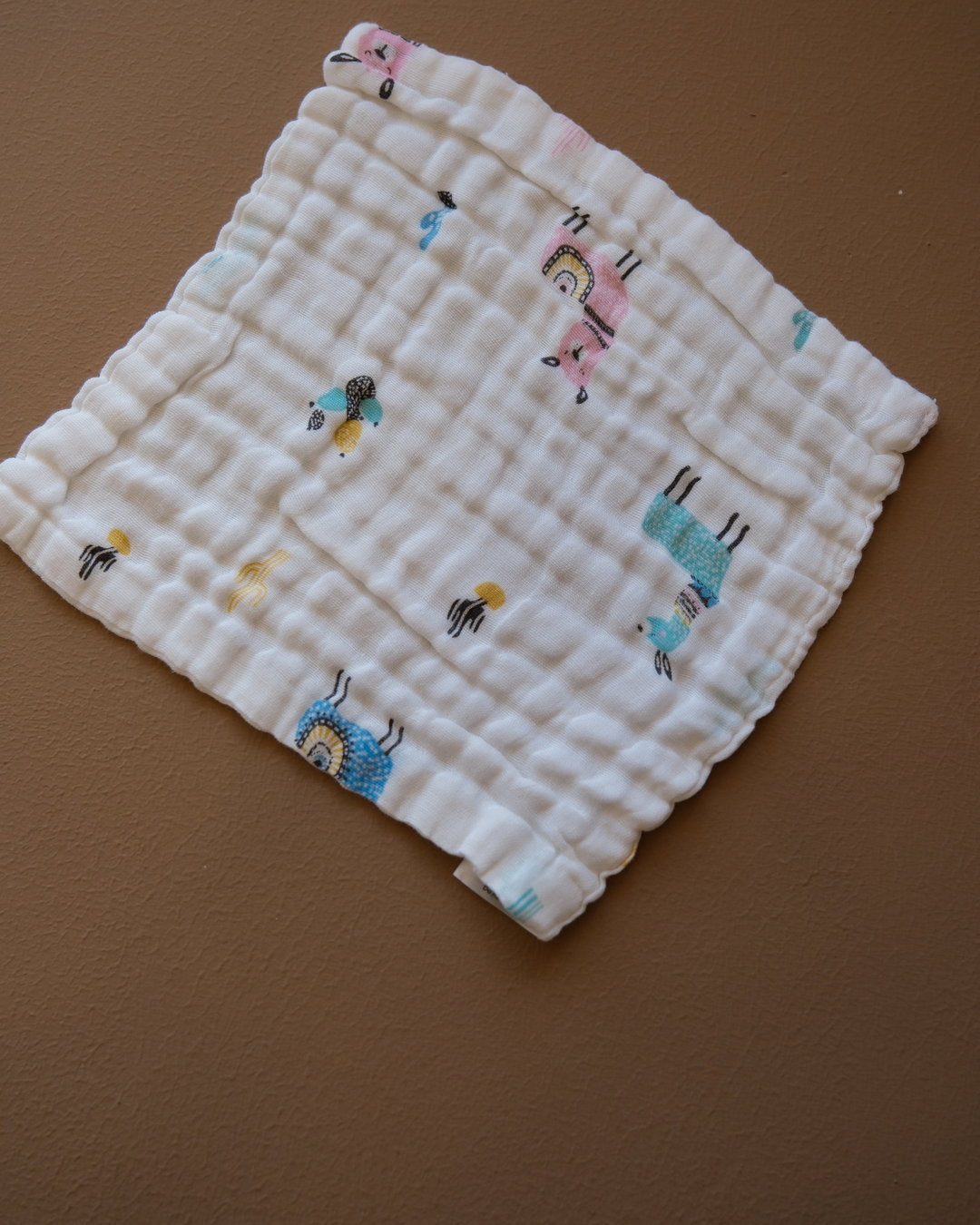 Six-layer white muslin baby face towel with assorted colorful printed designs
