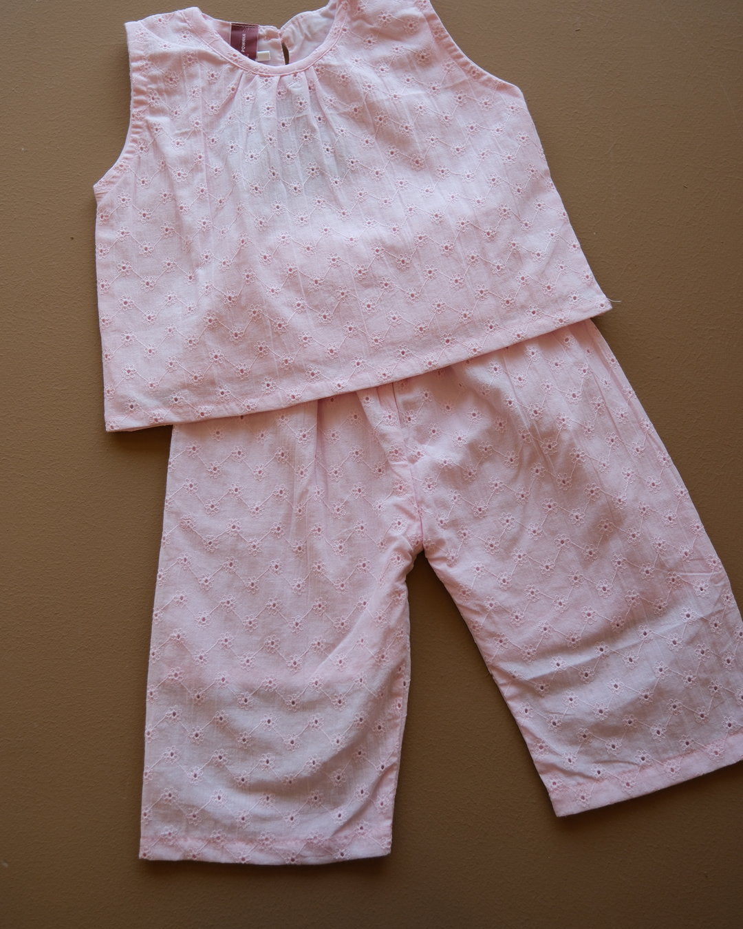 Soft pink sleeveless floral eyelet jumpsuit with wide-leg pants
