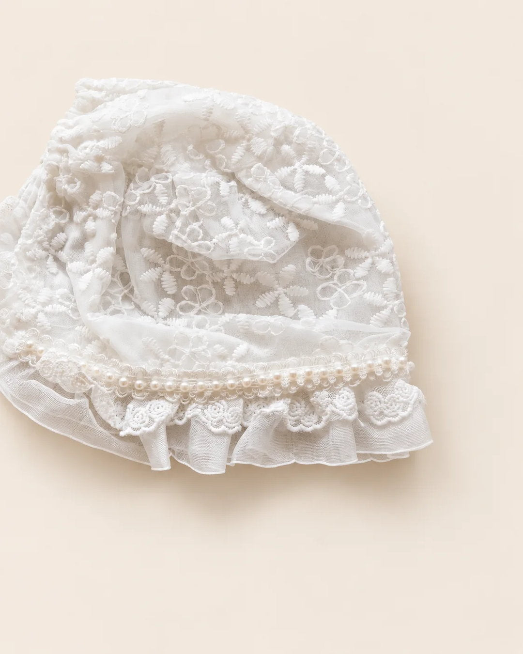 Delicate floral lace baby bonnet with tie straps