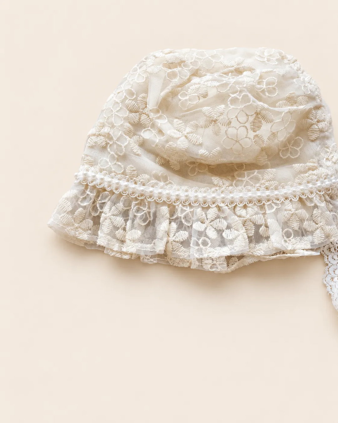 Delicate floral lace baby bonnet with tie straps
