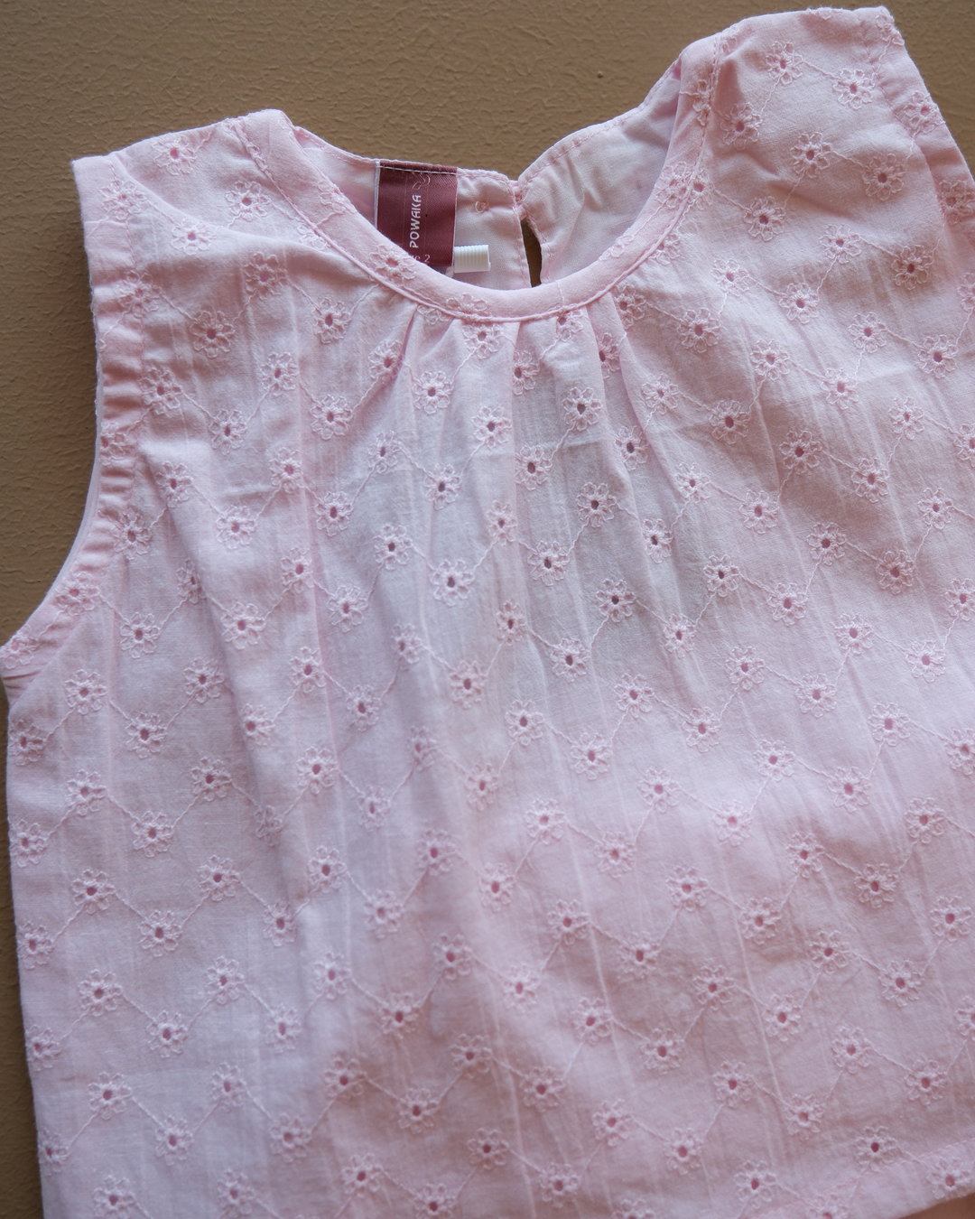 Soft pink sleeveless floral eyelet jumpsuit with wide-leg pants