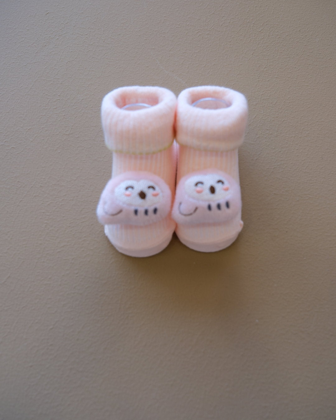 Assorted pastel baby socks with embroidered animal faces