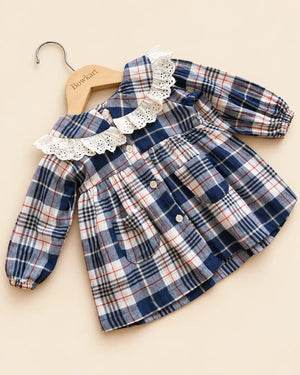 Navy blue plaid girls' frock with eyelet lace collar, long sleeves, buttons, and front pockets