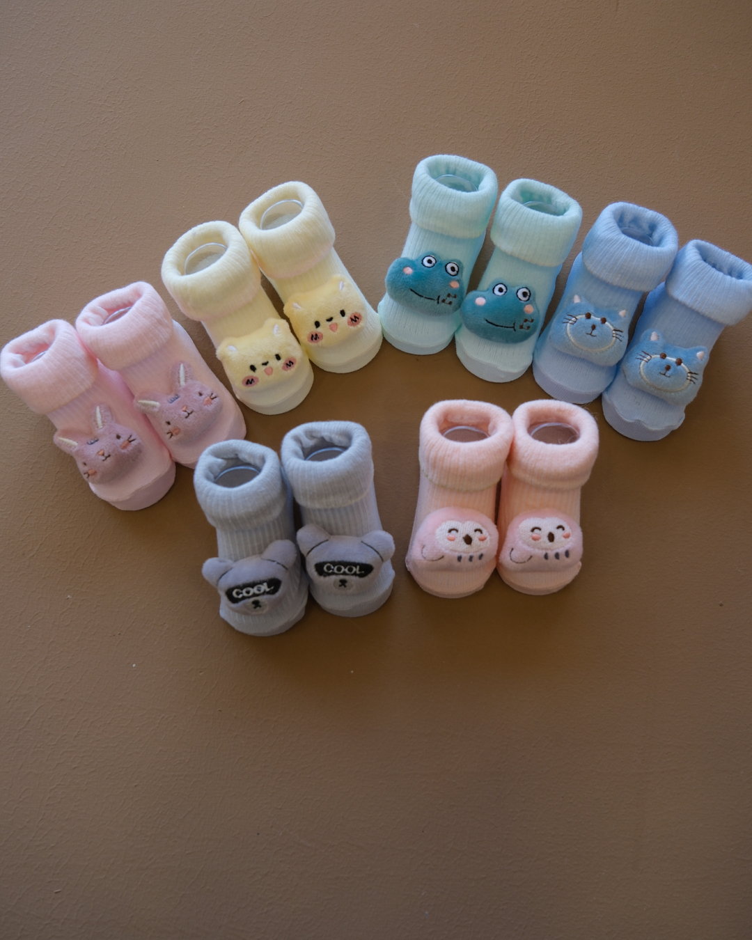 Assorted pastel baby socks with embroidered animal faces