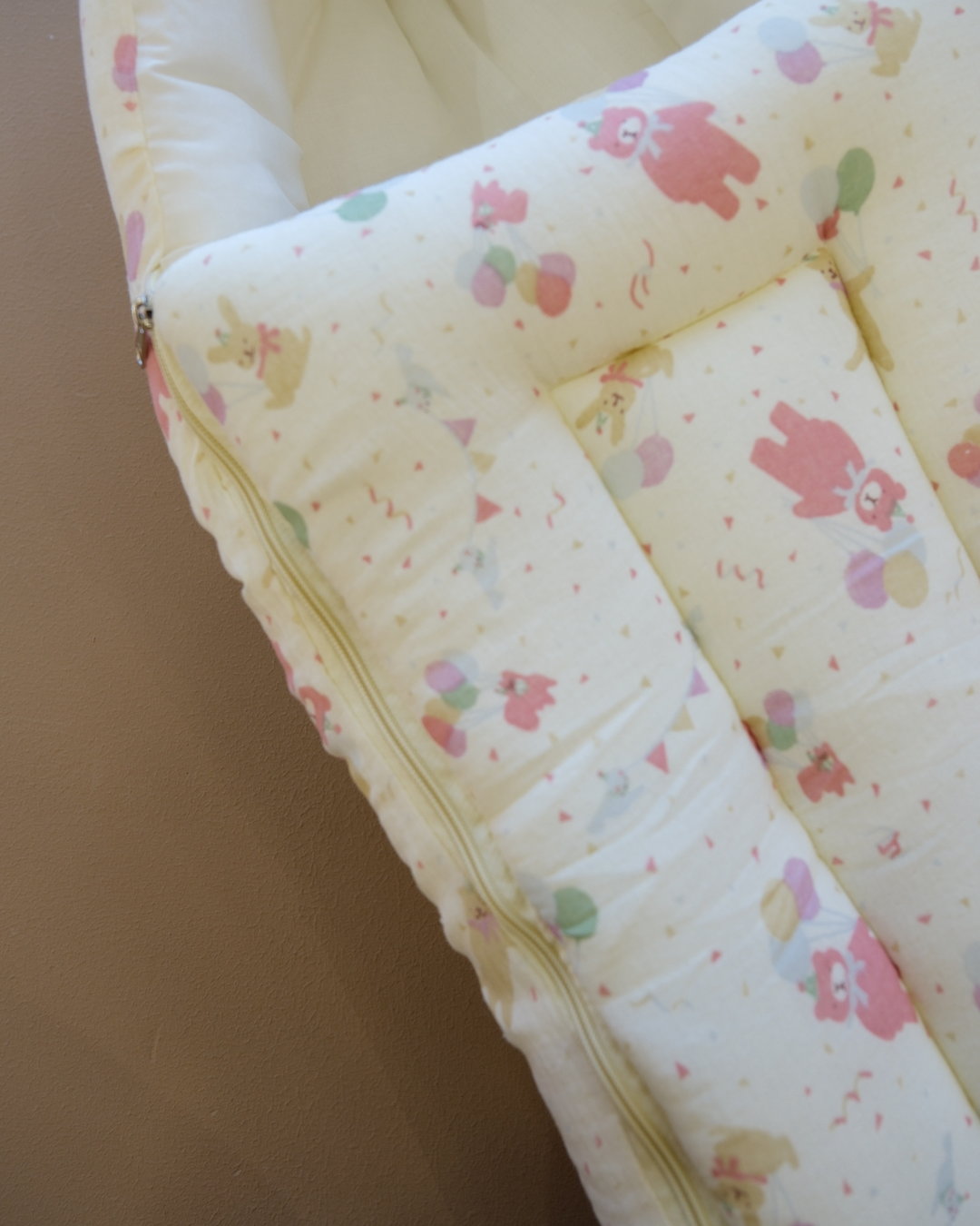 Ivory padded newborn sleeping bag with pink and green floral print