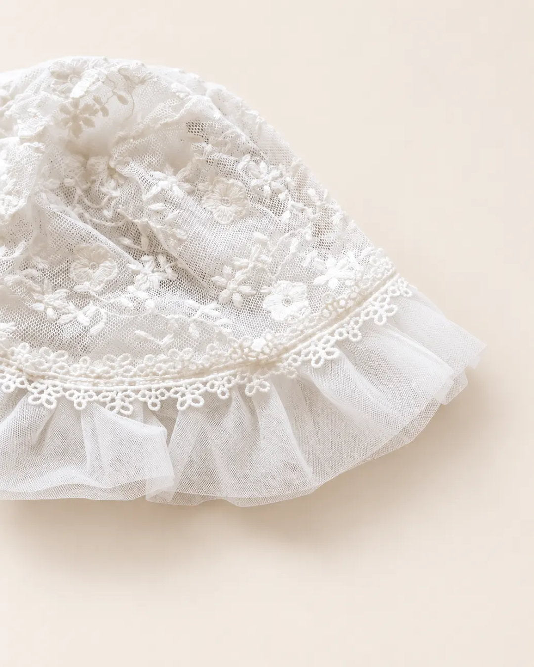 Delicate floral lace baby bonnet with tie straps