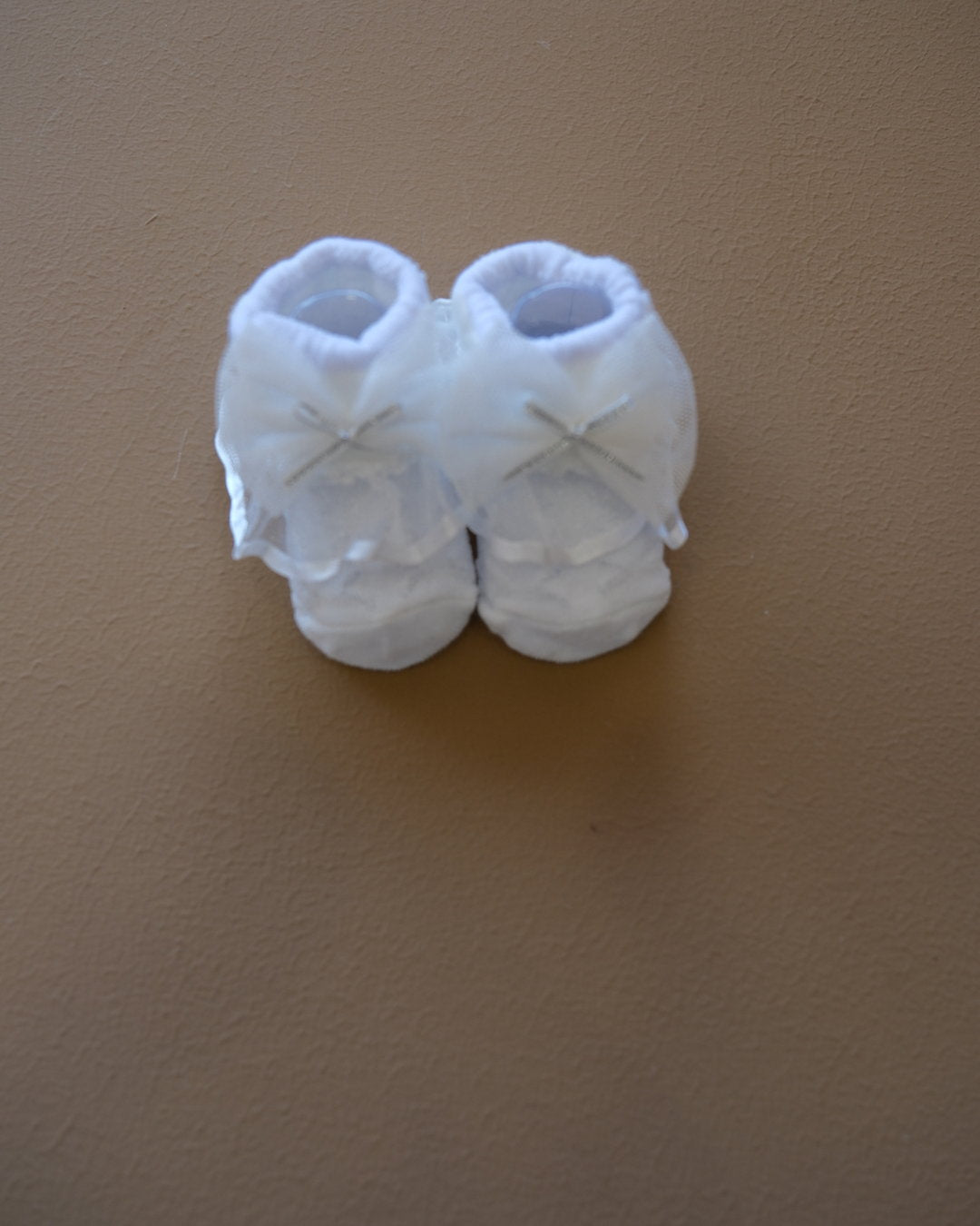 Newborn baby socks with decorative bows in pastel colors