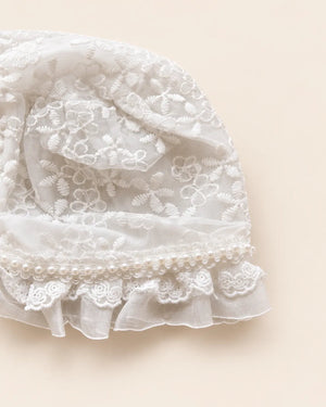 Delicate floral lace baby bonnet with tie straps