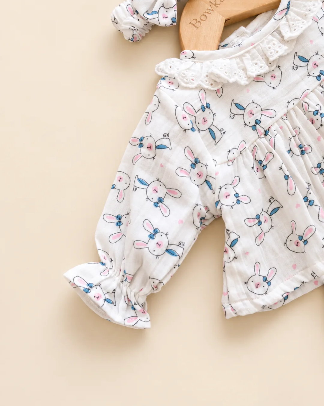 White bunny print baby clothing set with ruffled top, bloomers, and matching headband