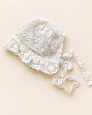 Delicate floral lace baby bonnet with tie straps