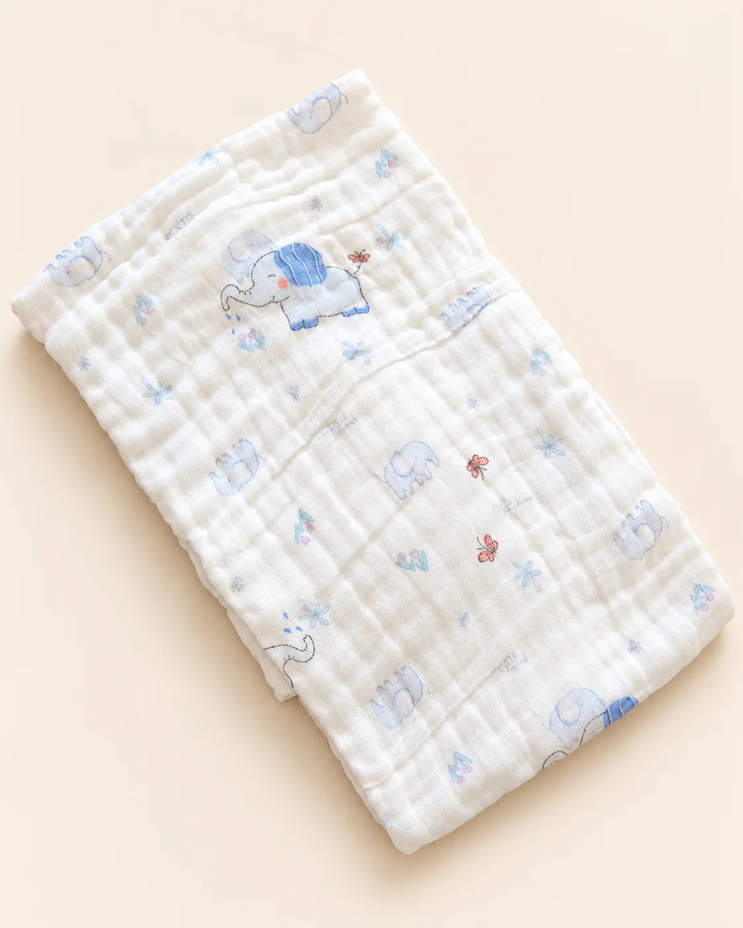 Printed muslin baby towel with playful elephant, unicorn, vehicle, and multicolor designs